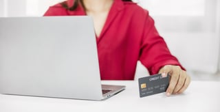 Woman holding credit card online